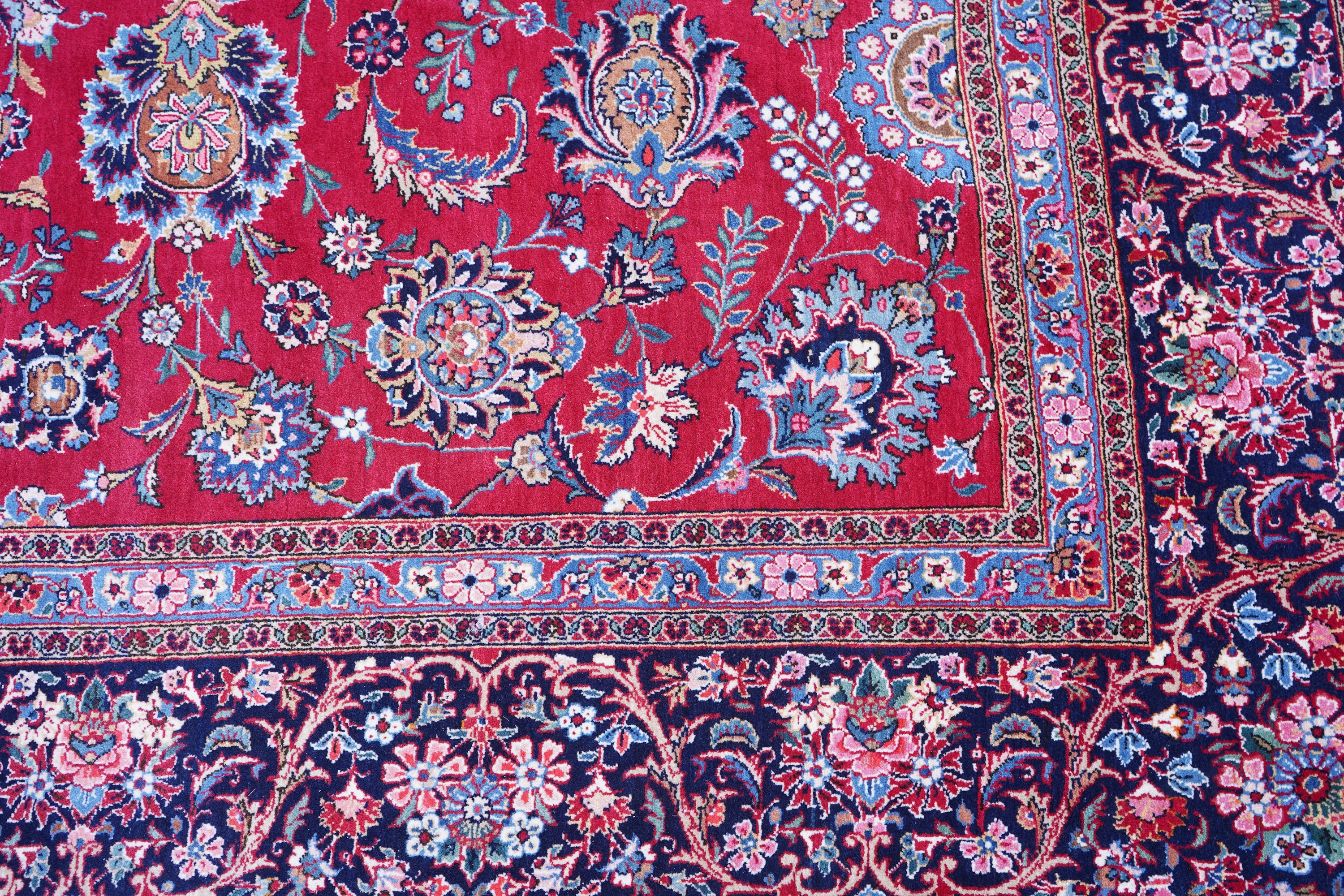 A Kashan burgundy ground carpet